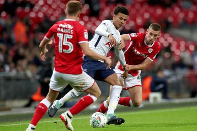 Tottenham Hotspur's Dele Alli (centre) and Barnsley's Joe Williams (right) battle for the ball during the Carabao Cup, third round match at Wembley Stadium, London. (Picture: PA)