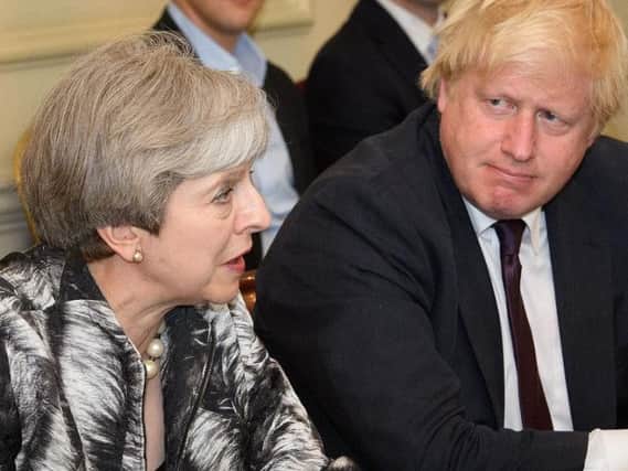 Loose cannon: Boris Johnson with Theresa May. The Prime Minister must demand her Cabinet back the position on Brexit - or any dissenters should resign forthwith.