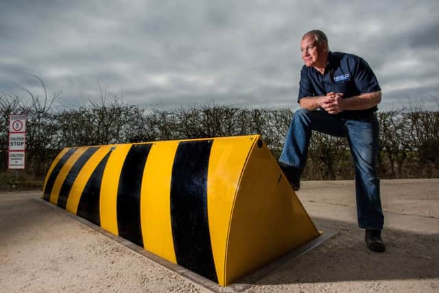 Product design and development chief Rod Heald perched on an HT1-
Commander road blocker.