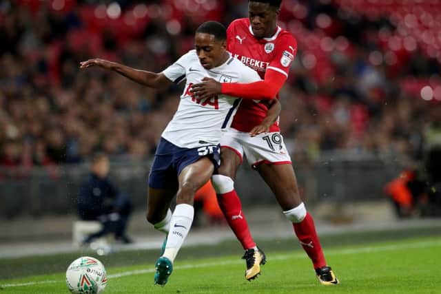 Tottenham Hotspur's Kyle Walker-Peters (left) and Barnsley's Ike Ugbo (right) battle for the ball during the Carabao Cup, third round match at Wembley Stadium, London. (Picture: PA)