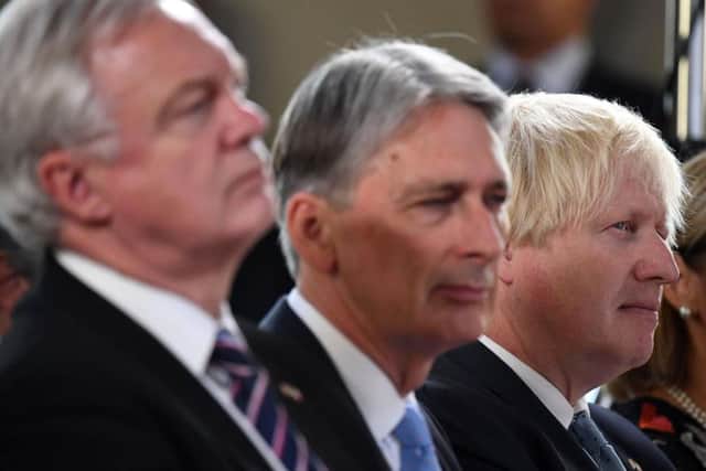 Brexit Secretary David Davis, Chancellor Philip Hammond and Foreign Secretary Boris Johnson listen as Prime Minister Theresa May delivers a speech in Florence, Italy, where she set out her plans for a transitional period from the formal date of Brexit in March 2019, expected to last two years, before moving to a permanent trade deal.