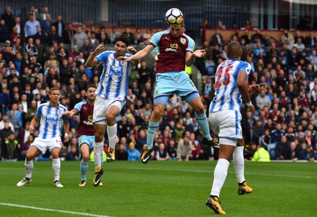 Burnley's Chris Wood jumps highest to head the ball during the Premier League match at Turf Moor. Picture: PA.