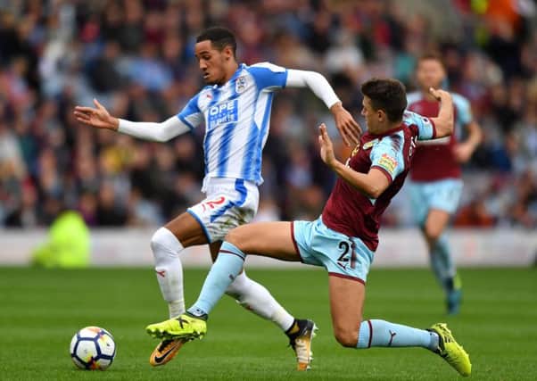 Huddersfield Town's Tom Ince (left) and Burnley's Matthew Lowton battle for the ball . Picture: Anthony Devlin/PA
