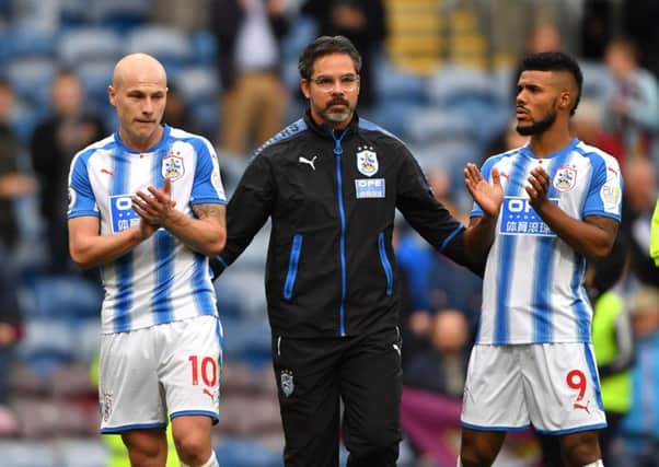 Huddersfield Town manager David Wagner (centre) with Aaron Mooy (left) and Elias Kachunga.
