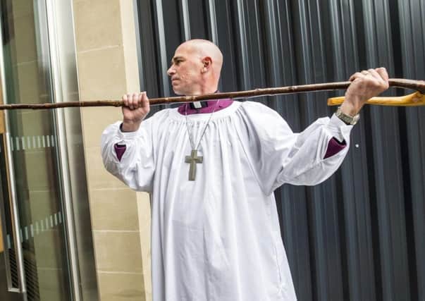 The Right Reverend Pete Wilcox knocks on the door of Sheffield Cathedral three times, as tradition dictates, before his installation as the city's new bishop