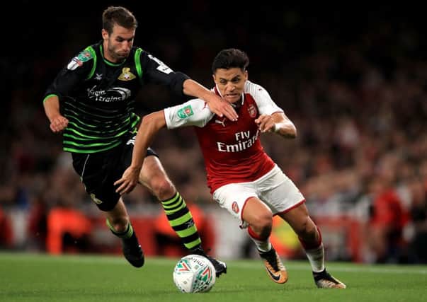 Doncaster Rovers' Matty Blair duels with Arsenal's Alexis Sanchez during the midweek Carabao Cup match (Picture: John Walton/PA Wire).