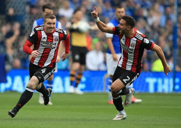John Fleck, left, is tracked down by Sheffield United team-mate George Baldock after opening the scoring early on at Hillsborough where the visitors beat Sheffield Wednesday 4-2 in the Championship (Picture: Mike Egerton/PA Wire).