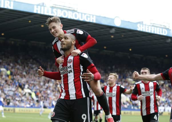 Sheffield United's Leon Clarke celebrates with David Brooks. Clarke scored twice in the 4-2 win over Sheffield Wednesday at Hillsborough (Picture: Simon Bellis/Sportimage).