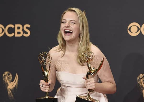 EMMY WINNER: Elisabeth Moss posing with her awards for outstanding lead actress in a drama series and outstanding drama series for The Handmaid's Tal" at the 69th Primetime Emmy Awards.  Photo by Jordan Strauss/Invision/AP