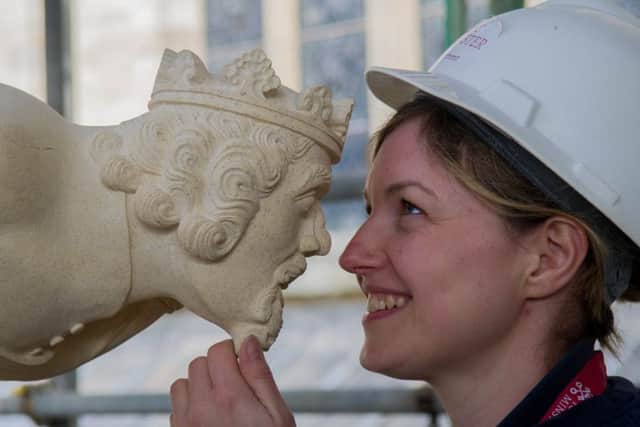 York Minster Stonemason Victoria Darley, looking at her carving of King Solomon.