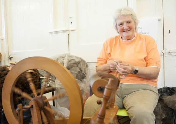 Sue Woodcock, pictured at her spinning wheel.