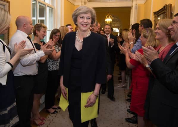 Theresa May enters 10 Downing Street, London, after becoming Prime Minister. Following a humiliating election result, she must now restore party morale to retain power.