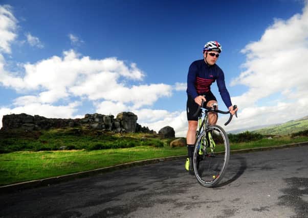 Cyclist Liam Wilton rides past the Cow and Calf, Ilkley..28th September 2017 ..Picture by Simon Hulme