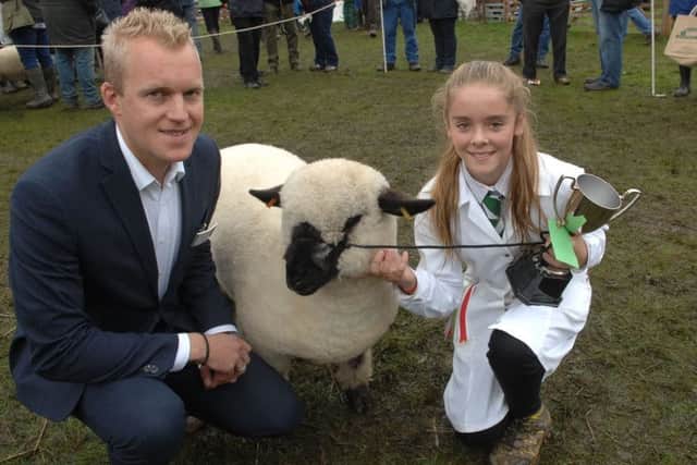 Winning young handler Amelie Rogers, 12, with Chris O'Mahony of sponsors Dacre, Son and Hartley.