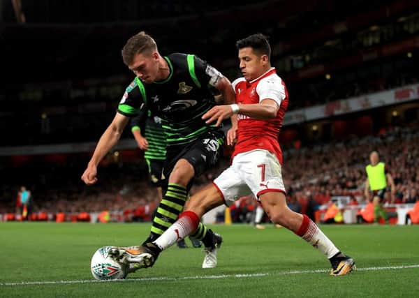Centre-half Joe Wright denies Arsenals Alexis Sanchez during Doncaster Rovers narrow recent defeat in the Carabao Cup at Emirates Stadium (Picture: John Walton/PA Wire).
