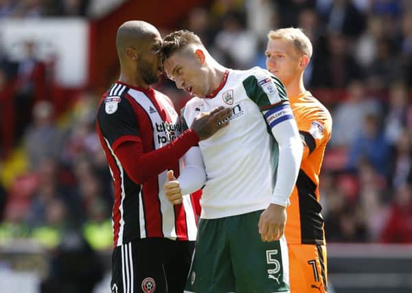 FLASHPOINT: Angus MacDonald clashes with Sheffield United's Leon Clarke at Bramall Lane in August. Picture: Simon Bellis/Sportimage