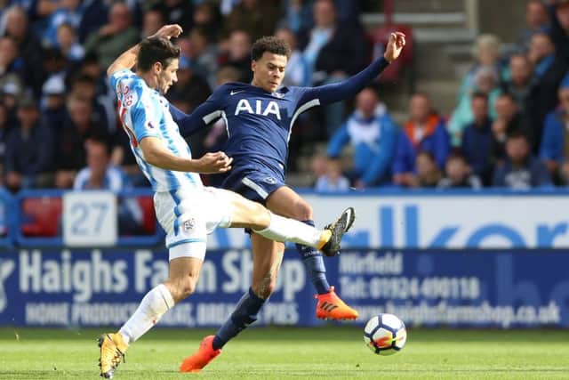 My ball: Huddersfield Town's Christopher Schindler and Tottenham Hotspur's Dele Alli battle for possession.
Picture: Nigel French/PA