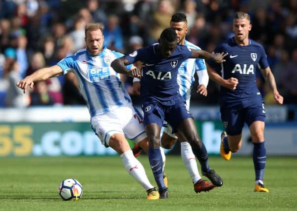 Huddersfield Town's Laurent Depoitre and Tottenham Hotspur's Davinson Sanchez battle for the ball. Picture: Nigel French/PA