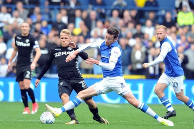 DERBY DUEL: 
Leeds' Samuel Saiz tackled by Wednesday's David Jones. Picture: Tony Johnson.