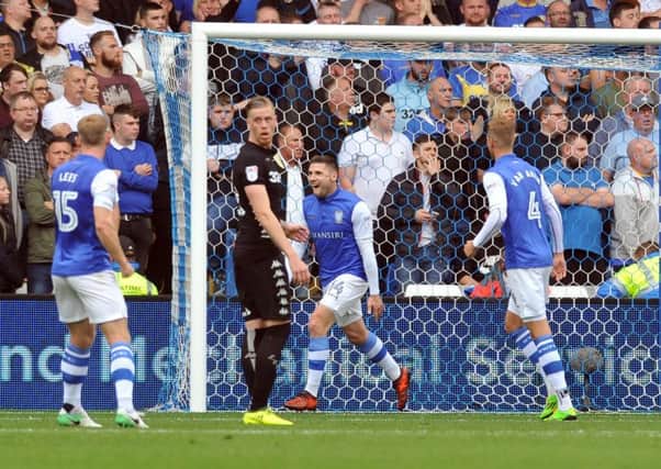 Gary Hooper, second right, runs away to celebrate the first of his two goals in Sheffield Wednesdays 3-0 defeat of Leeds United in yesterdays Championship match at Hillsborough (Picture: Tony Johnson).