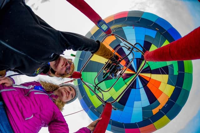 Pilot of hot air balloon Thunderbolt, Claire Westwood, (left), of Huddersfield, and crew member Clare Brewster, keeping a look out during their flight.