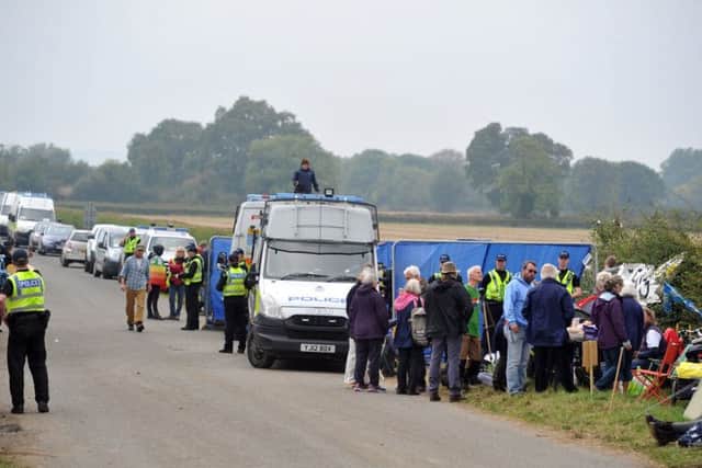 A scene from last Wednesday, when North Yorkshire Police worked to free protesters chained together in the entrance to the Third Energy site. Picture by Tony Johnson.