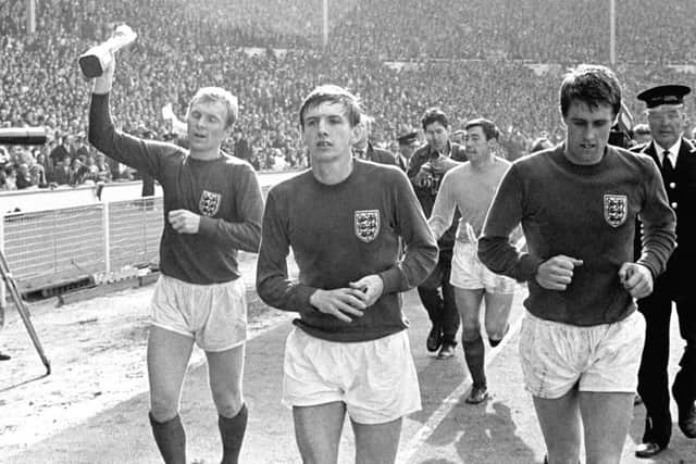Legends: West Ham United players Bobby Moore, Martin Peters and Geoff Hurst during the England team's lap of honour at Wembley following the World Cup final in 1966.