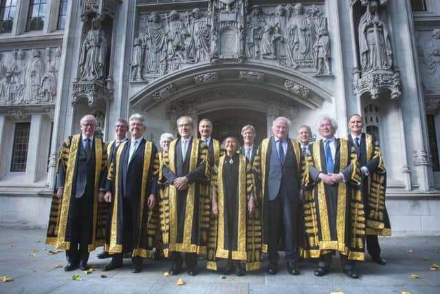 Lady Hale (centre) poses with other new justices after she was sworn in as the first female president of the UK's highest court, the Supreme Court, in Parliament Square, central London. PRESS ASSOCIATION Photo. Picture date: Monday October 2, 2017. See PA story LEGAL Judges. Photo credit should read: Victoria Jones/PA Wire