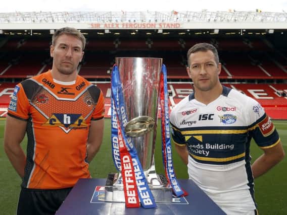 Castleford Tigers' Michael Shenton and Leeds Rhinos' Danny McGuire stand next to the Super League Grand Final trophy at Old Trafford
