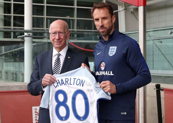 England manager Gareth Southgate presents Sir Bobby Charlton with a signed shirt. Sir Bobby will be 80 next week and a training pitch at St Georges Park has been re-named in the World Cup winners honour (Picture: Nick Potts/PA Wire).