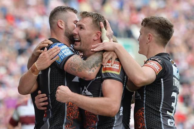 Castleford's Michael Shenton is congratulated by his team-mates after scoring a try against Wigan (Picture: SWPIx.com)