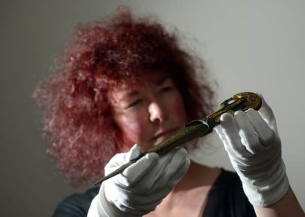 HISTORY: Joann Fletcher, who is hosting workshops for pupils, with an ancient Egyptian dagger with an ivory handle from 1600BC, part of an exhibition in Barnsley. PIC: Scott Merrylees
