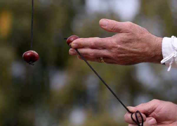 A competitor takes part in the annual World Conker Championships. PIC: PA