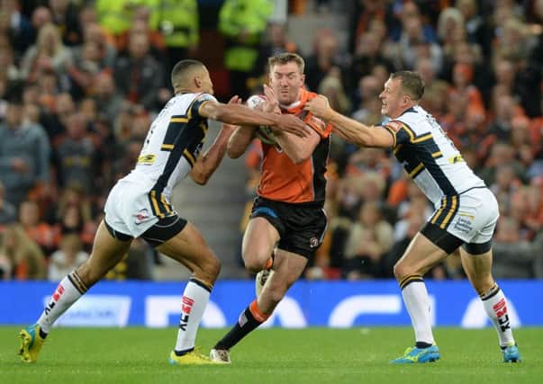 NO WAY THROUGH: Leeds Rhinos' Kallum Watkins and Danny McGuire close the door on Castleford captain Michael Shenton at Old Trafford on Saturday.  Picture: Bruce Rollinson