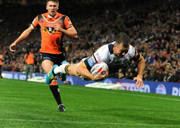 Danny McGuire dives in for the Rhinos' second try.