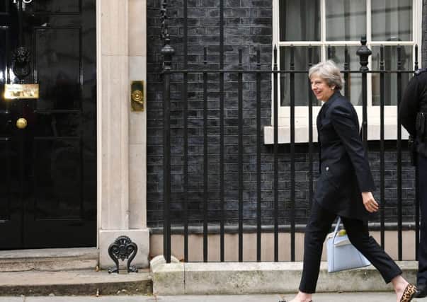 Theresa May arriving at 10 Downing Street. How long will she remain as Prime Minister?