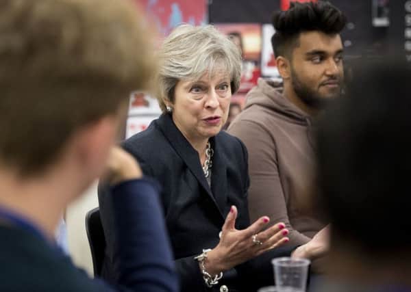 Prime Minister Theresa May talks to staff and pupils during a visit to the Dunraven School in Streatham, south London, ahead of the publication of details of the Government's Race Disparity Audit.