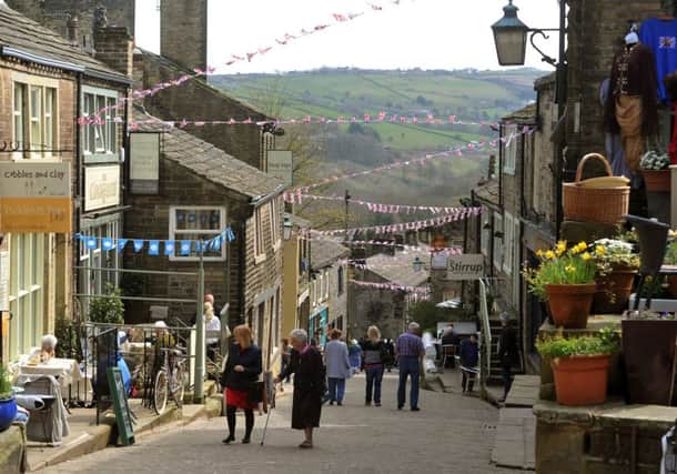 Main Street in Haworth decked in bunting last year to celebrate the 200th anniversary of the birth of Charlotte BrontÃ«.  Picture by Tony Johnson
