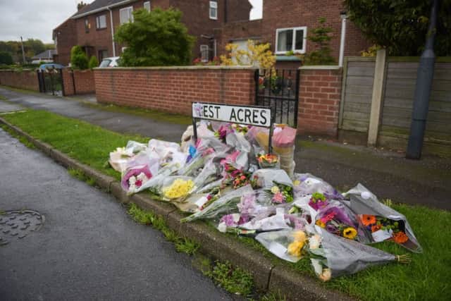 Flowers are laid at the scene where Kaitlin Mitchell, 12, was killed by a hit-and-run driver as she got off the school bus, in Byram, North Yorks., October 10 2017.