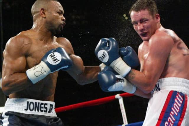 Roy Jones Jr.,left, punches Clinton Woods during the Light Heavyweight Championship of the World Match in Portland, Ore., Saturday, Sept. 7, 2002. (AP Photo/John Gress)