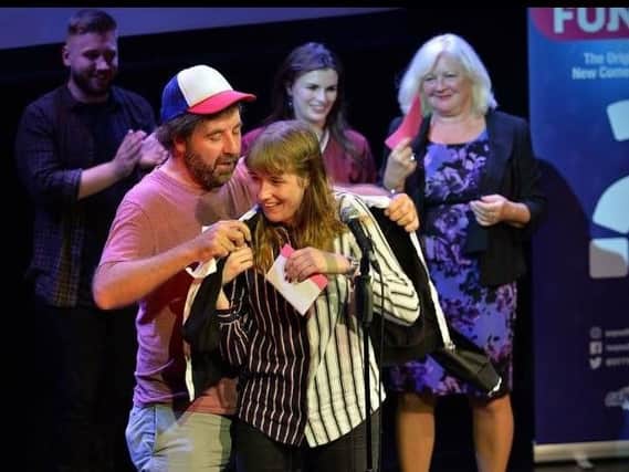 Harrogate comedian Maisie Adam, centre, receiving first prize in the UK's So You Think You're Funny? competition from David ODoherty at the Edinburgh Fringe.