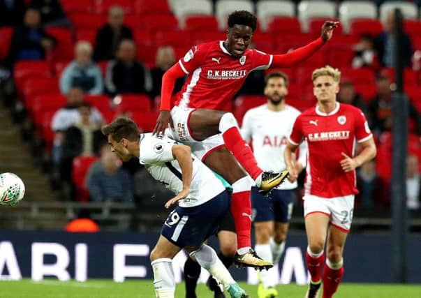 Barnsley's Ike Ugbo battles for the ball against Tottenham's Harry Winks. Picture: Jonathan Brady/PA
