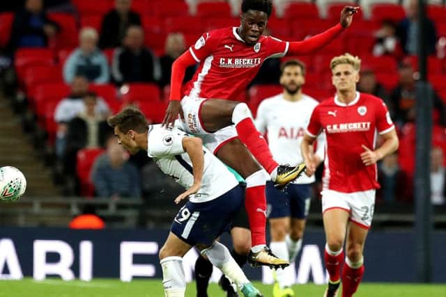 Barnsley's Ike Ugbo battles for the ball against Tottenham's Harry Winks. Picture: Jonathan Brady/PA