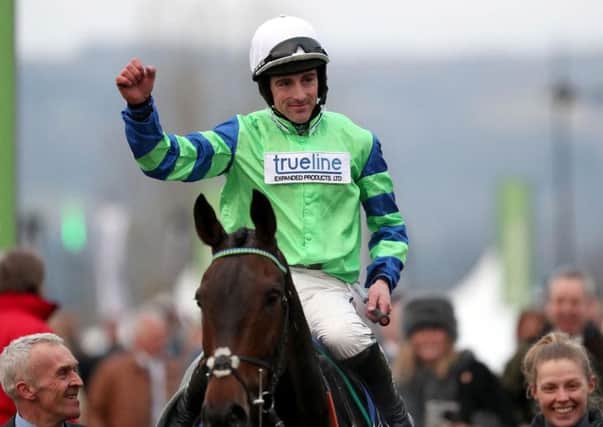 Jockey Brian Hughes celebrates on board Ballyalton after victory in the Close Brothers Novices' Handicap Chase during Champion Day of the 2016 Cheltenham Festival at Cheltenham Racecourse.
