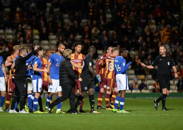 Managers Richie Wellens and Stuart McCall come onto the pitch as referee Christopher Sarginson loses control of the situation.