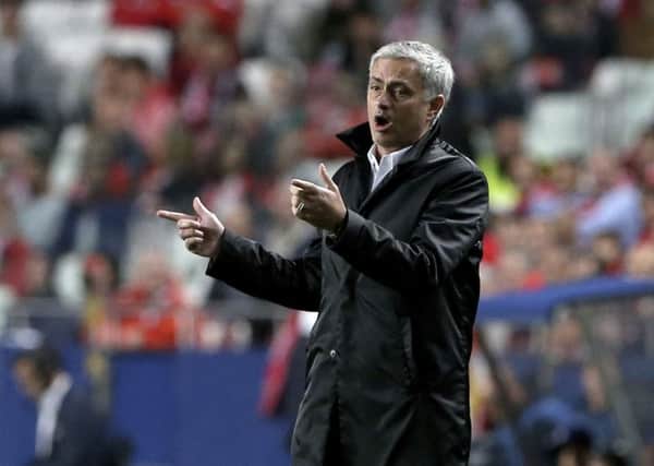 Manchester United coach Jose Mourinho gives instructions to his players during a Champions League group A soccer match between Manchester United and Benfica at Benfica's Luz stadium. (AP Photo/Armando Franca)
