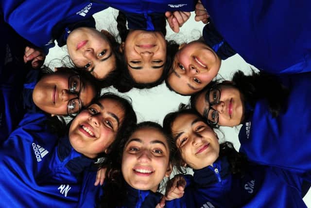 No 'I' in team. There is a togetherness about the girls' cricket team at Carlton Bolling College. (JPress).