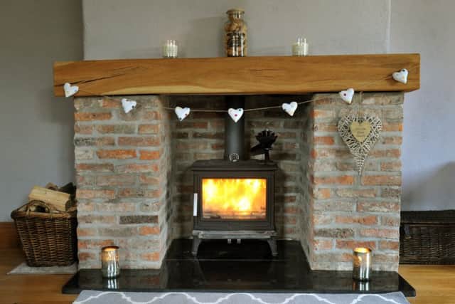 The fireplace is built from reclaimed bricks from the demolished house and a piece of oak