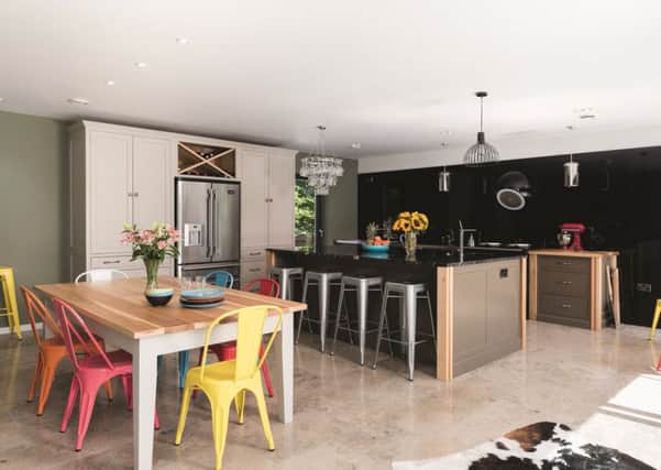 The open plan living kitchen with bespoke units and dining table by The Main Company, Green Hammerton