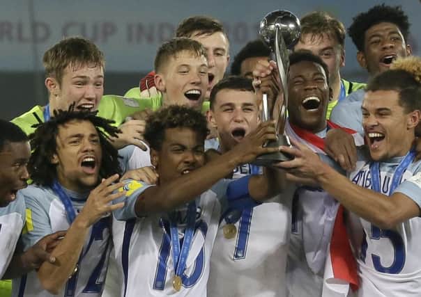 England players celebrates with the trophy after winning the FIFA Under-17 World Cup in Kolkata, India, by defeating Spain 5-2 from two goals behind (Picture: Anupam Nath/AP).